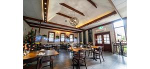 a restaurant with tables and chairs and a christmas tree at Nowra Motor Inn in Nowra