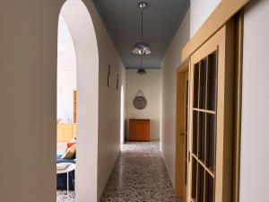 a hallway with white walls and an open door at Casa Lagò Lagò Panoramic Apartment in Ranzanico