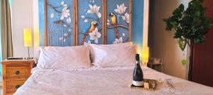 a bedroom with a bed with a bottle of wine on it at Incanto del Garda in Monzambano +77 photos