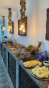 a buffet line with many plates of food on it at Pousada No Alto da Serra Conservatória in Conservatória