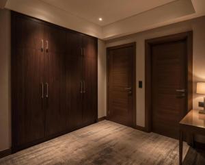 a hallway with wooden cabinets and a desk in a room at Amiron Hotel in Dushanbe