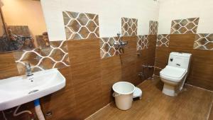 a bathroom with a white toilet and a sink at Hotel virat inn in Gwalior