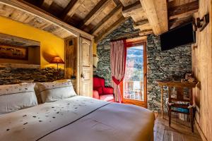 a bedroom with a bed in a room with a window at La Luge D'Antan Maison d'Hôtes & SPA in Brusson +64 photos