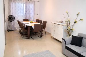 a kitchen and dining room with a table and chairs at Makepe Bungalow Style in Douala