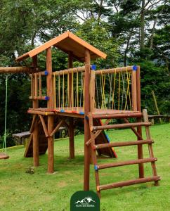 a wooden play structure in a park at Pousada No Alto da Serra Conservatória in Conservatória