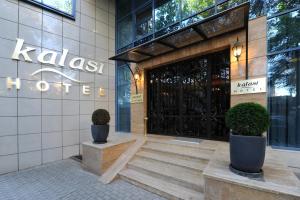 a lobby of a hotel with a door and potted plants at Kalasi Hotel in Tbilisi City