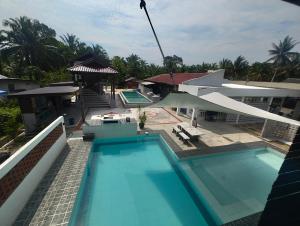 an aerial view of a house with a swimming pool at Tein homestay in Rengit