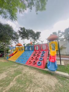 a childrens playground with a colorful play equipment at Fiona Luxury Resort in Gazipur