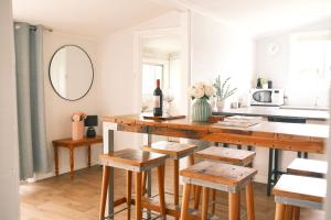 a kitchen with a wooden table and stools at Longford Cottage in Longford