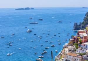 a group of boats in a large body of water at Hotiday Positano Volte Alte in Positano