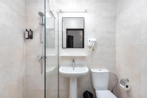 a bathroom with a toilet and a sink and a shower at Kalasi Hotel in Tbilisi City +29 photos