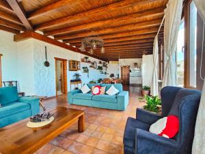 a living room with blue couches and a table at Casa Morro Herreno in Las Breñas