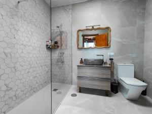 a bathroom with a shower and a toilet and a mirror at Casa Morro Herreno in Las Breñas +35 photos