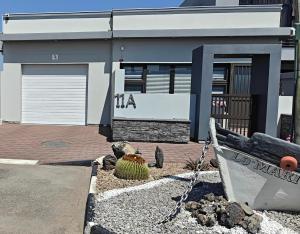 a building with a boat in front of it at Lagoon Luxury Suites in Walvis Bay