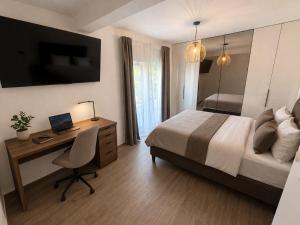 a bedroom with a bed and a desk with a laptop at Villa RoseMary in Split +33 photos