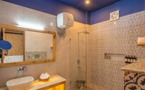 a bathroom with a shower and a sink at THE CEDAR CASTLE in Mukteshwar +56 photos