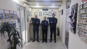 a group of three men standing in a room at Panorama Apartment in Belgrade