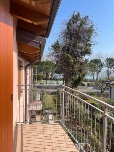 a balcony of a house with a tree at Villa Aurora Apartments in Sirmione