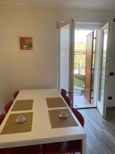 a dining room table and chairs with a view of a patio at Villa Aurora Apartments in Sirmione