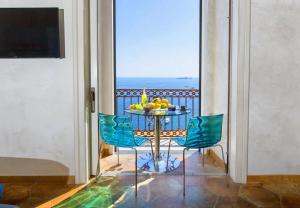 a balcony with a table with fruit on it at Hotiday Positano Volte Alte in Positano
