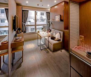 a living room with a table and a desk at Oootopia West in Hong Kong