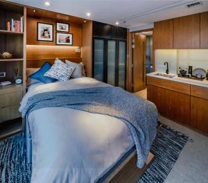 a bedroom on a yacht with a bed and a sink at Oootopia West in Hong Kong