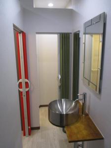 a bathroom with a sink and a mirror at Naoshima Kowloon in Naoshima +55 photos