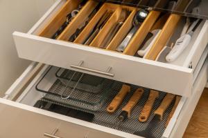 a drawer filled with cooking utensils in a kitchen at Het Herenhuis Middelburg in Middelburg