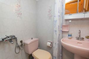 a small bathroom with a toilet and a sink at Cycladic Grandma's Apartments in Parikia +21 photos