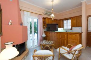 a living room with a fireplace and a tv at Cycladic Grandma's Apartments in Parikia