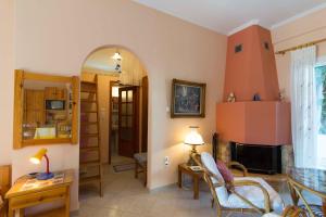 a living room with a table and a fireplace at Cycladic Grandma's Apartments in Parikia