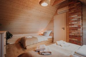 a bedroom with two beds in a wooden room at Ulinia Zacisze Dom Superior 90m2 - Fala - Mierzeja - Wydma in Ulinia +93 photos