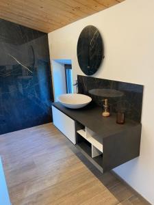 a bathroom with a sink and a mirror at Agriturismo Il Borghetto in Montedinove +35 photos