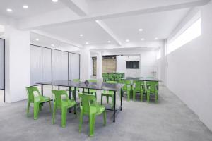 a conference room with a table and green chairs at FabHotel Vishwas in Aurangabad