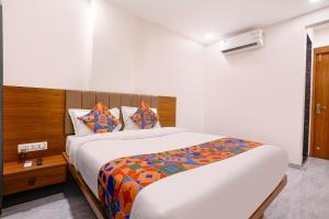a bedroom with a large bed in a room at FabHotel Vishwas in Aurangabad