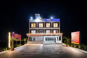 a building with a sign on top of it at night at FabHotel Vishwas in Aurangabad