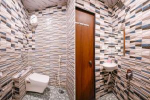 a bathroom with a toilet and a sink at FabHotel Vishwas in Aurangabad +31 photos