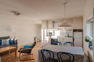 a kitchen and living room with a table and chairs at Äleklinta in Äleklinta
