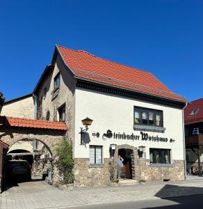 a building with a sign on the side of it at Ferienwohnung Marie in Kurort Steinbach-Hallenberg
