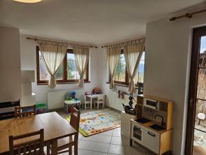 a kitchen and living room with a table and a dining room at Villa Park Lipno 206 in Lipno nad Vltavou