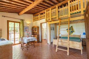 a bedroom with a bunk bed and a table in a room at Agriturismo Bike Hotel Podere Giarlinga in Massa Marittima