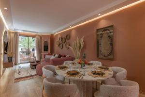 a living room with a table and chairs at GUELIZ Seven Stays in Marrakesh