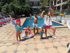 a group of children standing next to a swimming pool at Гостевой дом Асель in Cholpon-Ata
