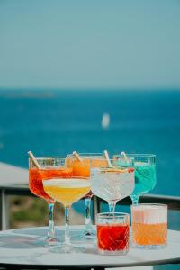 a group of four wine glasses sitting on a table at Hotel Ker Moor Saint-Quay Portrieux in Saint-Quay-Portrieux