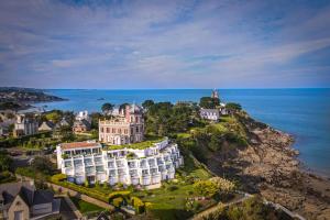 an aerial view of a large building on a hill next to the ocean at Hotel Ker Moor Saint-Quay Portrieux in Saint-Quay-Portrieux