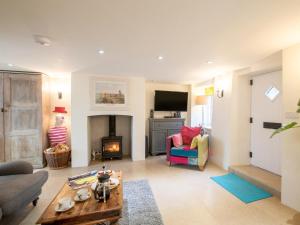 a living room with a couch and a fireplace at 3 Bed in Bridport oc-dc080 in Charmouth