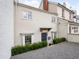 a white house with a blue door at 3 Bed in Bridport oc-dc080 in Charmouth