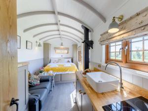 a room with a bed and a kitchen with a sink at 1 Bed in Beaworthy oc-82834 in Ashwater
