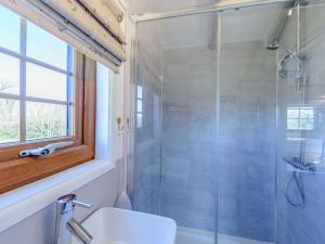 a bathroom with a shower and a toilet and a sink at 1 Bed in Beaworthy oc-82834 in Ashwater +23 photos