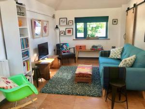 a living room with a blue couch and a table at 1 Bed in Okehampton oc-78087 in Hatherleigh